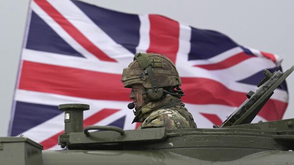 A British soldier sits in an AS90 at a military training camp in an undisclosed location in England, Friday, March 24, 2023.  - Sputnik International