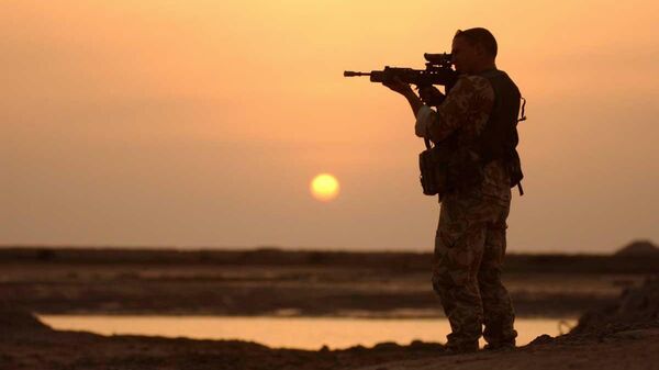 A Royal Marine from 42 Commando stands guard over a UK USA coalition held position on the Al Faw peninsular, in Iraq, March 23 2003.  - Sputnik International