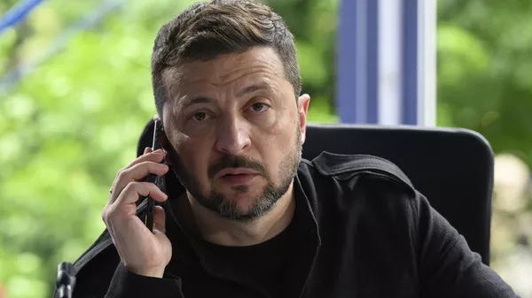 Volodymyr Zelensky speaks on the phone during a meeting at the European Political Community summit in Skanderbeg Square in Tirana, Albania, on Friday, May 16, 2025. - Sputnik International