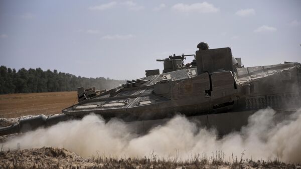 Israeli forces move along the border with the Gaza Strip, in southern Israel, Monday, May 19, 2025.  - Sputnik International