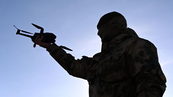 A man launches a drone  - Sputnik International