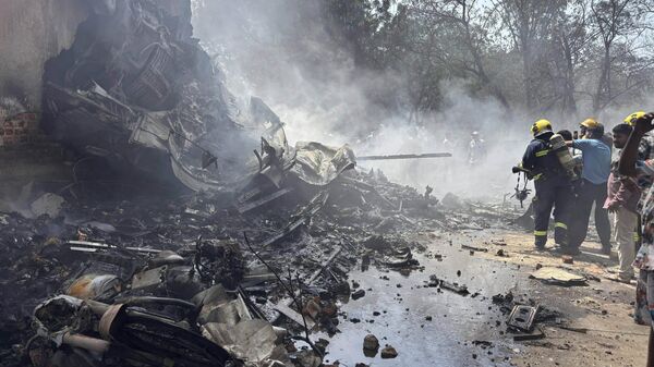 Firefighters work at the site of an airplane that crashed in India's northwestern city of Ahmedabad in Gujarat state, Thursday, June12, 2025.  - Sputnik International