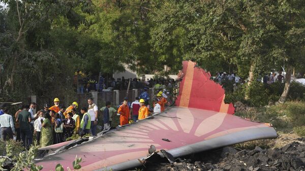 People stand around the debris of an airplane after it crashed in India's northwestern city of Ahmedabad in Gujarat state, Thursday, June 12, 2025.  - Sputnik International