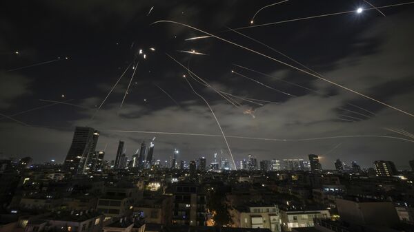 The Israeli Iron Dome air defense system fires to intercept missiles during an Iranian attack over Tel Aviv, Israel, Sunday, June 15, 2025. - Sputnik International