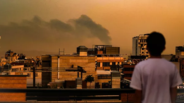 A general view of Tehran covered in smoke and dust following explosions after an Israeli airstrike - Sputnik International