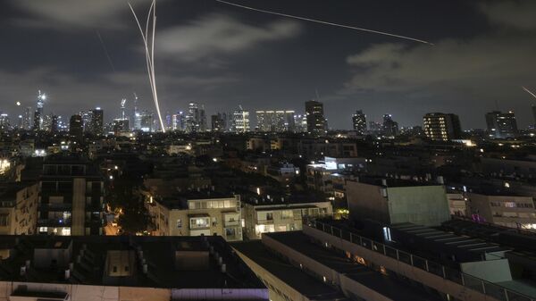 Israeli air defense system fires to intercept missiles during an Iranian attack over Tel Aviv, Israel, early Wednesday, June 18, 2025. - Sputnik International