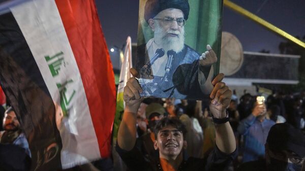 A portrait of Iran's Supreme Leader Ayatollah Ali Khamenei held during a protest against Israeli attacks on multiple cities across Iran, June 14, 2025. - Sputnik International