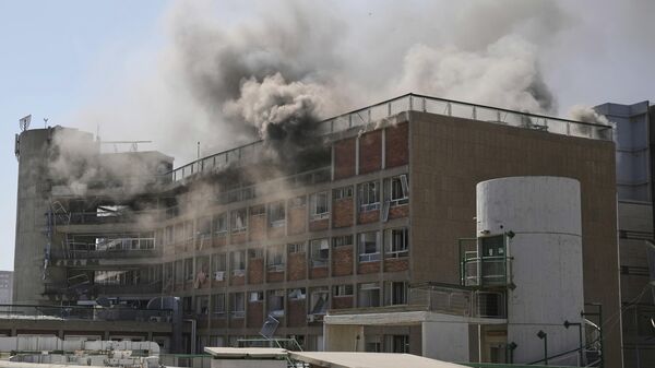 Smokes rises from a building of the Soroka hospital complex after it was hit by a missile fired from Iran in Beersheba, Israel. - Sputnik International