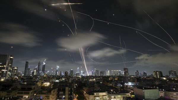 The Israeli Iron Dome air defense system fires to intercept missiles during an Iranian attack over Tel Aviv, Israel, early Wednesday, June 18, 2025.  - Sputnik International
