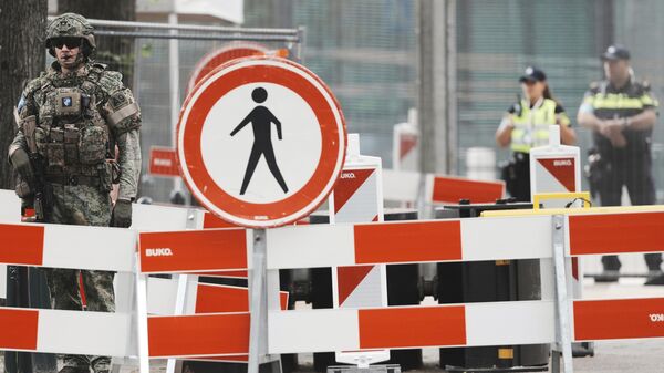 Security patrol behind a barrier around the venue of the NATO summit in The Hague, Netherlands, Tuesday, June 24, 2025. - Sputnik International