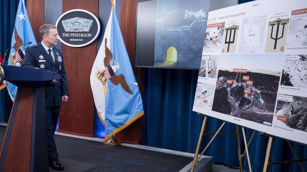 Joint Chiefs Chairman Gen. Dan Caine watches a test video of the ordinance used in the attack on the Iranian Fordow Fuel Enrichment Plant during a news conference at the Pentagon, Thursday, June 26, 2025 in Washington.  - Sputnik International