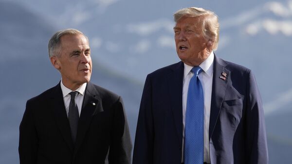 Canada's Prime Minister Mark Carney, listens as President Donald Trump speaks during a group photo at the G7 Summit, Monday, June 16, 2025, in Kananaskis, Canada - Sputnik International