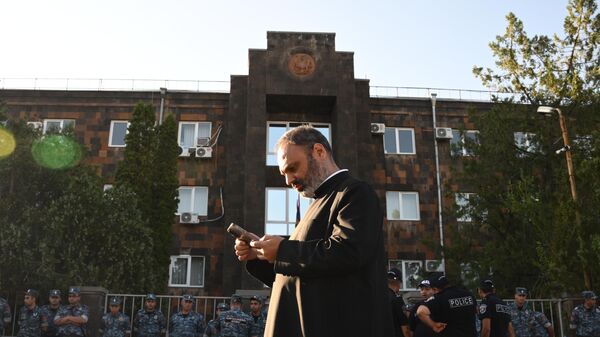 A priest and police officers outside a courthouse in Yerevan. A criminal case has been opened against Archbishop of Shirak of the Armenian Apostolic Church Mikael Ajapakhian, who is accused of publicly calling for the seizure of power, violation of territorial integrity, renunciation of sovereignty and violent overthrow of the constitutional order. On the night of June 28, Mikael Ajapakhian was arrested by a court decision for two months.
 - Sputnik International