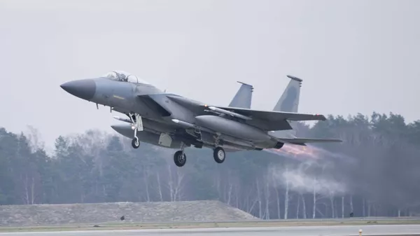 In this image provided by the US Air Force, a US Air Force F-15C Eagle assigned to the 493rd Fighter Squadron, Royal Air Force (RAF) Lakenheath, takes off in support of North Atlantic Treaty Organization enhanced air policing missions with the Polish Air Force at Lask Air Base, Poland, Feb. 15, 2022 - Sputnik International