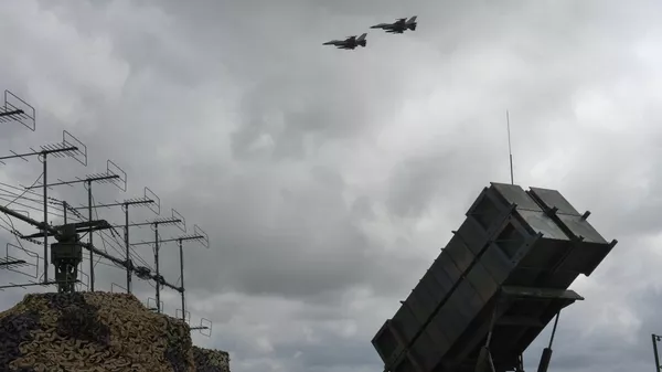 Ukrainian Air Force's F-16 fighter jets fly over a Patriot Air and Missile Defense System in an undisclosed location in Ukraine, Sunday, Aug. 4, 2024. - Sputnik International