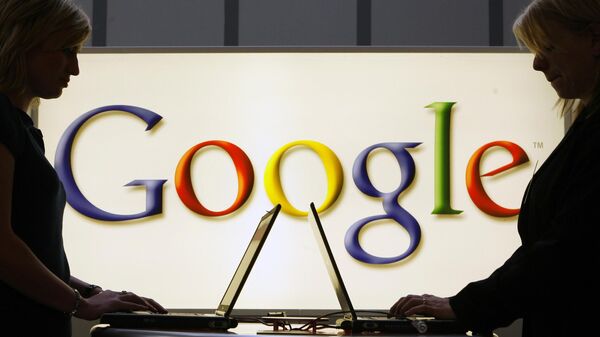 In this April 17, 2007 file photo, exhibitors work on laptop computers in front of an illuminated sign of the Google logo at the industrial fair Hannover Messe in Hanover, Germany. - Sputnik International