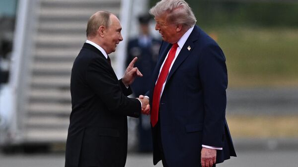 US President Donald Trump greets Russian President Vladimir Putin on the tarmac after they arrived to attend a meeting at Joint Base Elmendorf-Richardson in Anchorage, Alaska, the United States. August 15, 2025. - Sputnik International