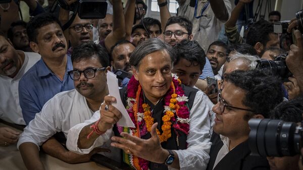 FILE- Senior Congress party leader Shashi Tharoor, right, shows his documents as he files his nomination papers for the position of Congress party president, at the party's headquarter in New Delhi, India, Sept. 30, 2022.  - Sputnik International