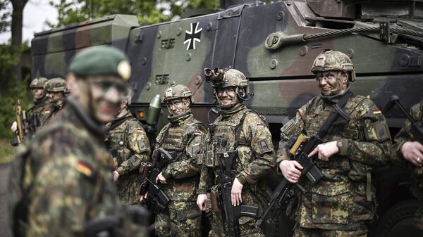 Soldiers of the German forces, Bundeswehr, stand in front of a Boxer military vehicle, a new type of armoured personnel carrier, at the Julius Leber Barracks in Berlin, Germany, Wednesday, April 24, 2024. Soldiers of the German forces, Bundeswehr, stand in front of a Boxer military vehicle, a new type of armoured personnel carrier, at the Julius Leber Barracks in Berlin, Germany, Wednesday, April 24, 2024. - Sputnik International