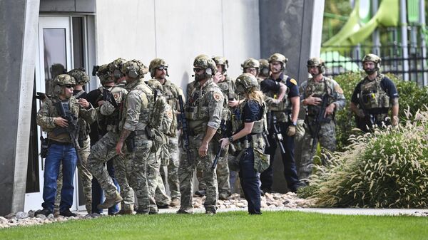 Law enforcement officials prepare to sweep a building at Utah Valley University, Wednesday, Sept. 10, 2025, in Orem, Utah, where conservative activist Charlie Kirk was shot and killed. - Sputnik International