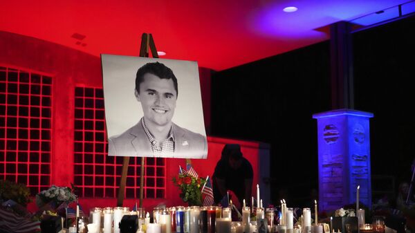 A photo of Charlie Kirk, the CEO and co-founder of Turning Point USA who was shot and killed, stands at his vigil - Sputnik International