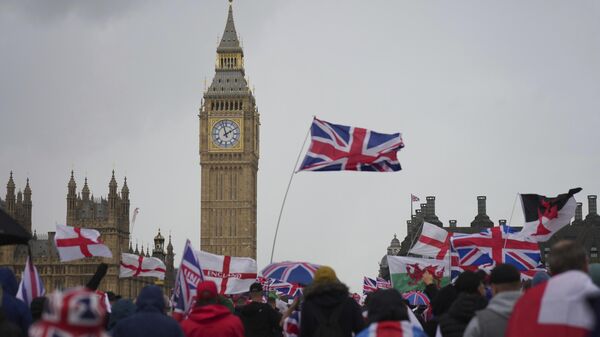 Demonstrators take part in the Tommy Robinson-led Unite the Kingdom march and rally near Westminster, London - Sputnik International