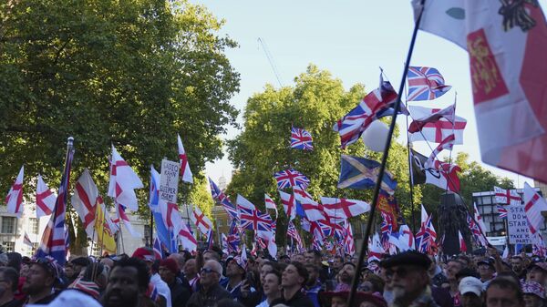 People demonstrate during the Tommy Robinson-led Unite the Kingdom march and rally, in London, Saturday Sept. 13, 2025.  - Sputnik International