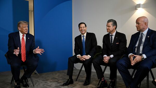 US President Donald Trump, left, speaks next to, from left, US Secretary of State Marco Rubio, US Defence Secretary Pete Hegseth and US' ambassador to NATO Matthew Whitaker, during a meeting with NATO Secretary General Mark Rutte at the NATO summit of heads of state and government in The Hague, Netherlands, Wednesday, June 25, 2025 - Sputnik International