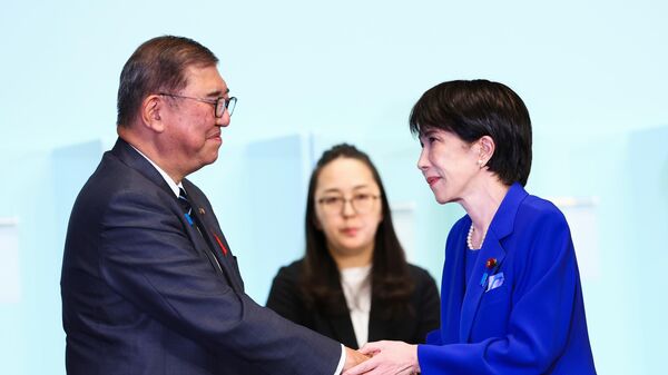 Newly-elected leader of Japan's Liberal Democratic Party (LDP) Sanae Takaichi, right, shakes hands with Prime Minister Shigeru Ishiba after winning the LDP leadership election i in Tokyo, Japan, Saturday, Oct. 4, 2025 - Sputnik International