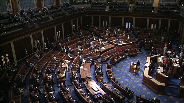 In this image from video, members of the House practice social distancing as they sit on the floor and in the public gallery above during debate on the coronavirus stimulus package on the floor of the House of Representatives at the US Capitol in Washington, Friday, March 27, 2020 - Sputnik International