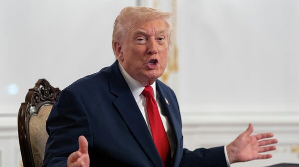 President Donald Trump speaks to reporters after speaking to troops via video from his Mar-a-Lago estate on Thanksgiving, Thursday, Nov. 27, 2025, in Palm Beach, Fla - Sputnik International