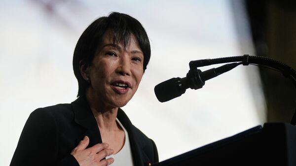 Japanese Prime Minister Sanae Takaichi, with President Donald Trump, speaks to members of the military aboard the USS George Washington, an aircraft carrier docked at a U.S. naval base, in Yokosuka, south of Tokyo, Tuesday, Oct. 28, 2025. (AP Photo/Mark Schiefelbein) - Sputnik International
