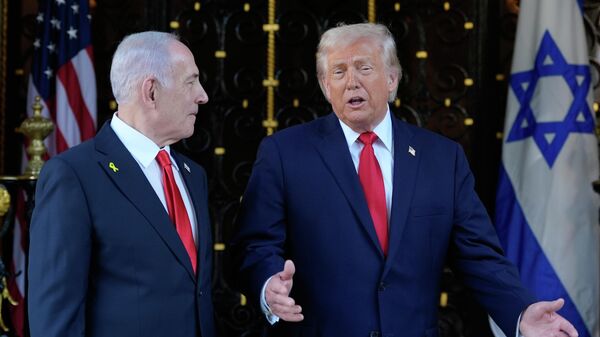 President Donald Trump speaks to reporters as he greets Israel's Prime Minister Benjamin Netanyahu at his Mar-a-Lago club, Monday, Dec. 29, 2025, in Palm Beach, Fla - Sputnik International