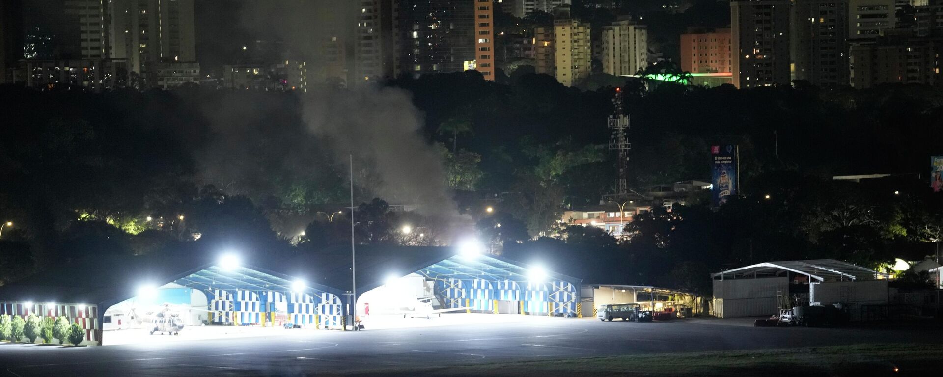 Smoke raises at La Carlota airport after explosions and low-flying aircraft were heard in Caracas, Venezuela, Saturday, Jan. 3, 2026. - Sputnik International, 1920, 04.01.2026
