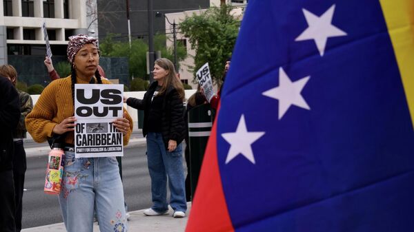 Protesters gather to denounce the U.S. attack on Venezuela on Saturday, Jan. 3, 2026, in Las Vegas.  - Sputnik International