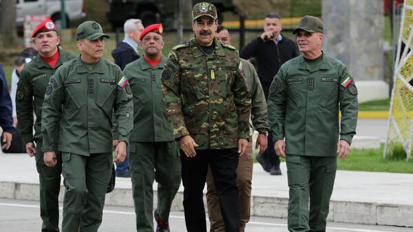 Venezuelan President Nicolas Maduro, center, Defense Minister Vladimir Padrino Lopez, right, and Gen. Domingo Hernandez arrive at a government-organized civic-military rally in Caracas, Venezuela, Tuesday, Nov. 25, 2025 - Sputnik International