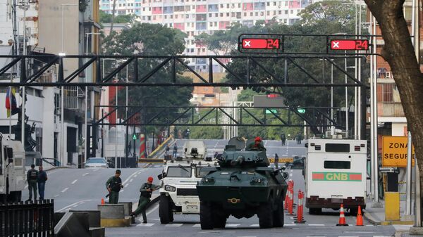 National Guard armored vehicles block an avenue leading to Miraflores presidential palace in Caracas, Venezuela, Saturday, Jan. 3, 2026 - Sputnik International