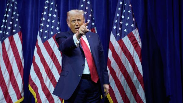 President Donald Trump points to the crowd as he walks off stage after speaking to House Republican lawmakers during their annual policy retreat, Tuesday, Jan. 6, 2026, in Washington - Sputnik International
