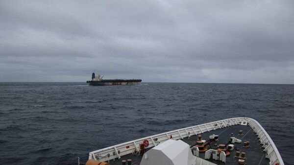 A handout image of the ship Marinera (Ex-Bella 1) seen in the distance, released on January 7, 2026.  US EUROPEAN COMMAND via X/Handout via REUTERS    - Sputnik International