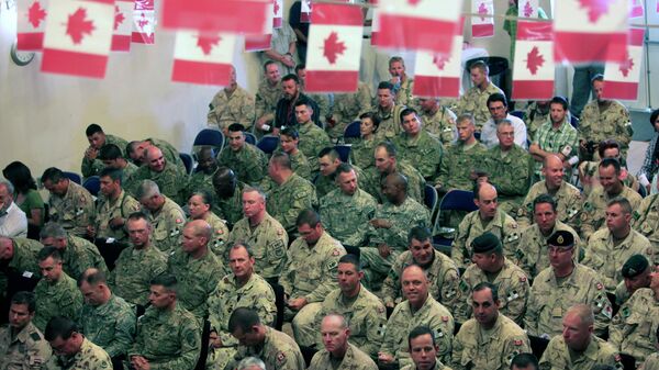 US and Canadians soldiers attend a transfer of command authority ceremony in Kandahar airbase in Afghanistan, Thursday, July 7, 2011 - Sputnik International