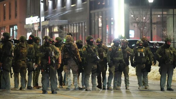 Federal agents gather during a noise demonstration protest in response to federal immigration enforcement operations in the city Sunday, Jan. 25, 2026, in Minneapolis. (AP Photo/Adam Gray) - Sputnik International