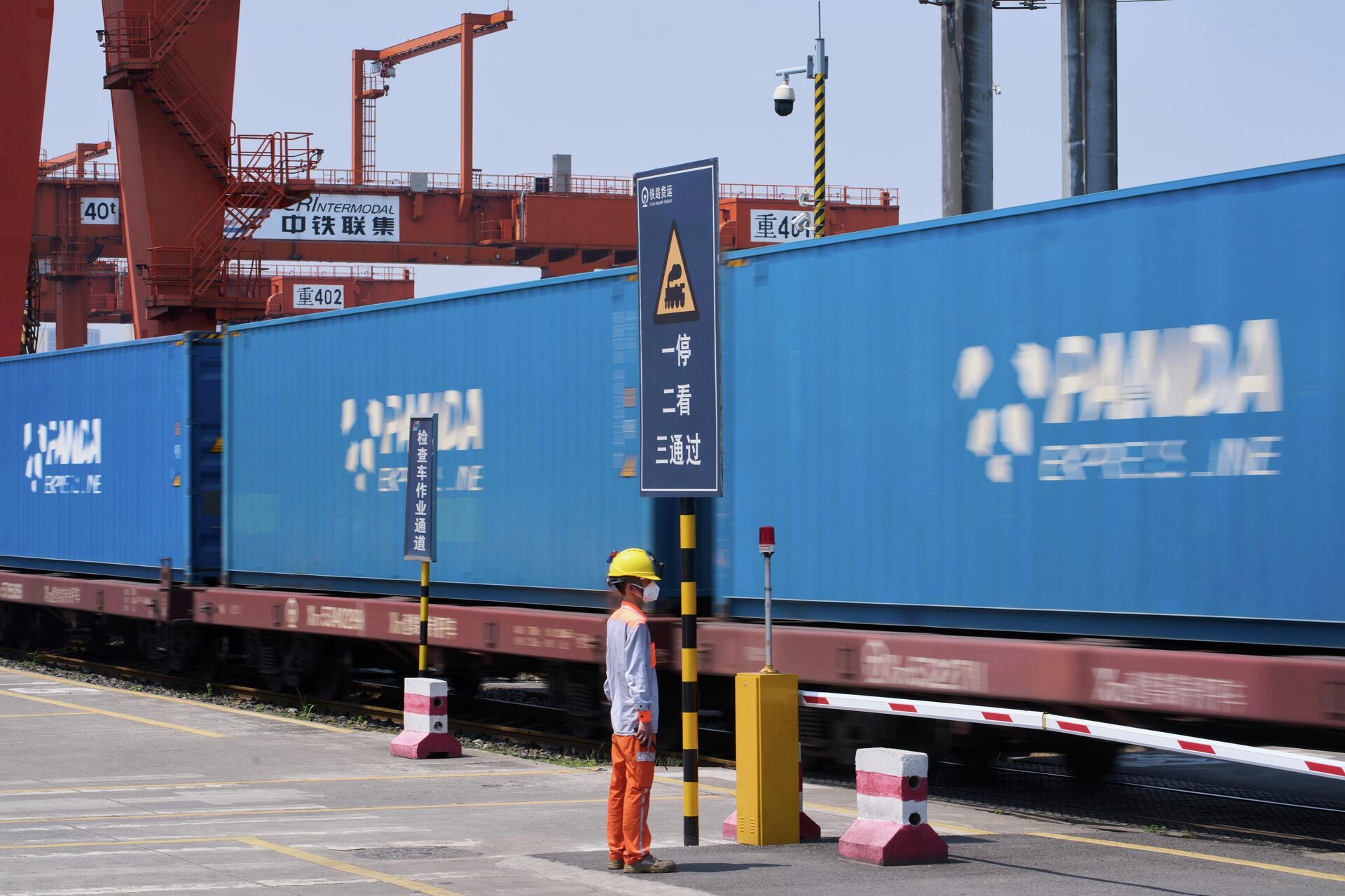 A worker stands watch as a train loaded with containers leaves the Chongqing Railway Container Terminal Station, in southwest China's Chongqing Municipality  - Sputnik International, 1920, 12.02.2026