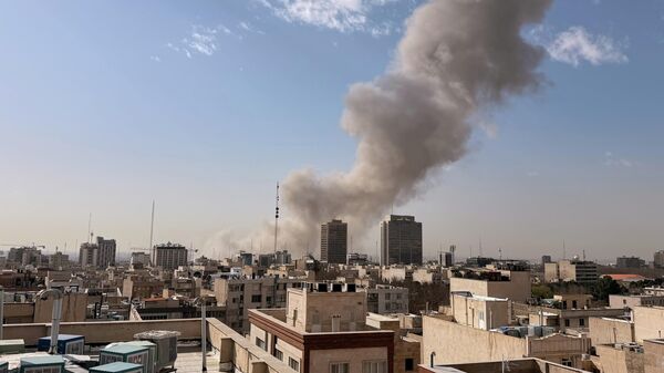 Smoke rises on the skyline after an explosion in Tehran, Iran, Saturday, Feb. 28, 2026.(AP Photo) - Sputnik International