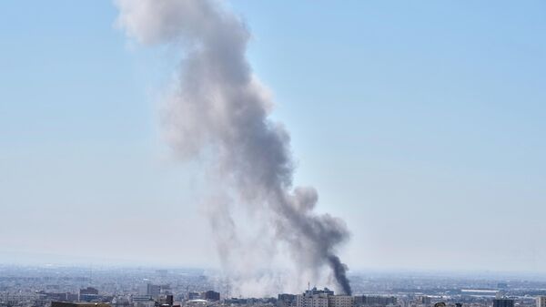 A plume of smoke rises after a strike in Tehran, Iran, Sunday, March 1, 2026. - Sputnik International