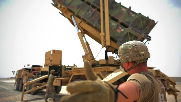 In this photo released by the U.S. Air Force, U.S. Army Spc. Scottlin Bartlett of the 5-52 Air Defense Artillery Battalion signals to a colleague while working near a Patriot missile battery at Al-Dhafra Air Base in Abu Dhabi, United Arab Emirates, May 5, 2021.  - Sputnik International