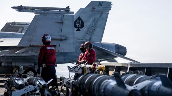 This image provided by US Central Command shows Navy sailors looking over ordnance on the flight deck of the USS Abraham Lincoln (CVN 72) in support of Operation Epic Fury on March 2, 2026.. - Sputnik International