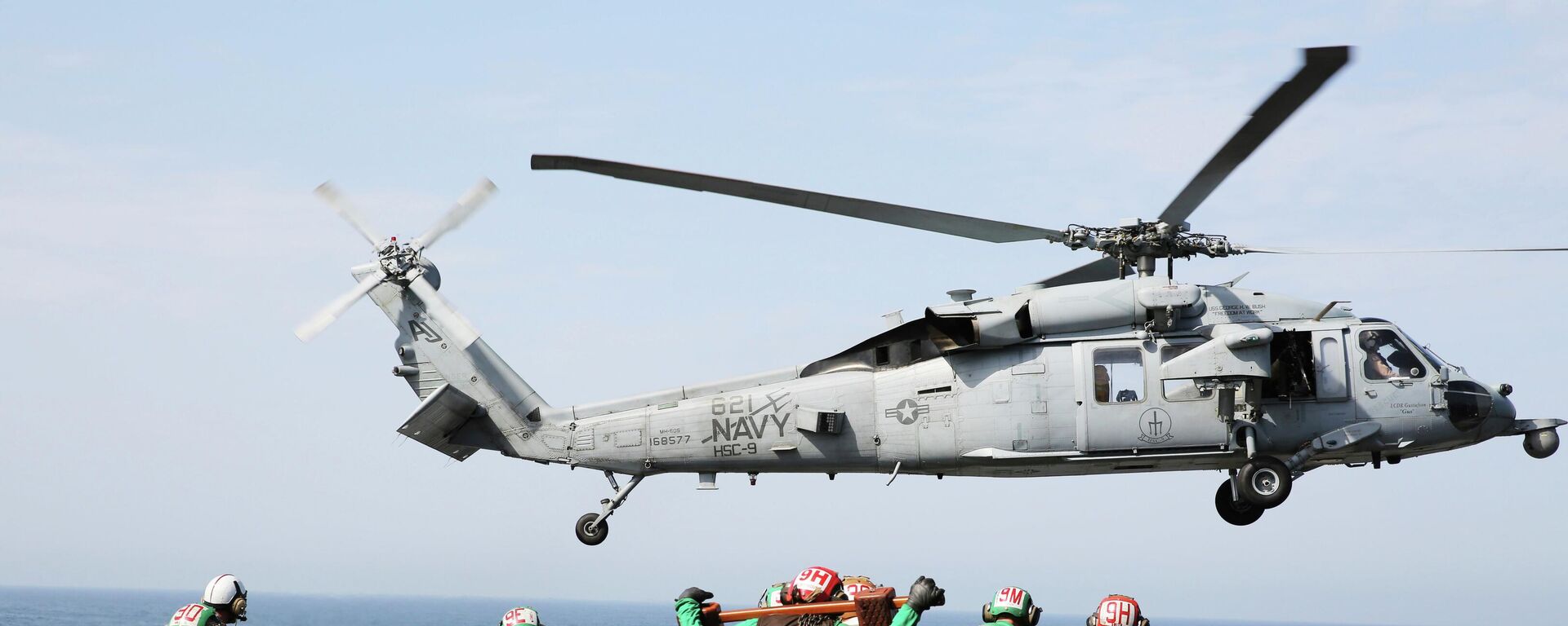 In this March 20, 2017 photograph, an MH-60 helicopter takes off from the USS George H.W. Bush as it travels toward the Strait of Hormuz.  - Sputnik International, 1920, 17.03.2026