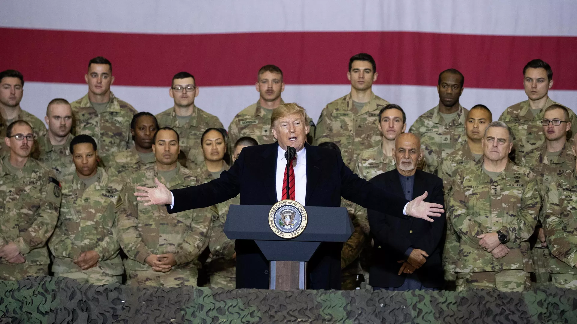 President Donald Trump, center, with Afghan President Ashraf Ghani and Joint Chiefs Chairman Gen. Mark Milley, behind him at right, while addressing members of the military during a surprise Thanksgiving Day visit, Thursday, Nov. 28, 2019, at Bagram Air Field, Afghanistan - Sputnik International, 1920, 19.03.2026