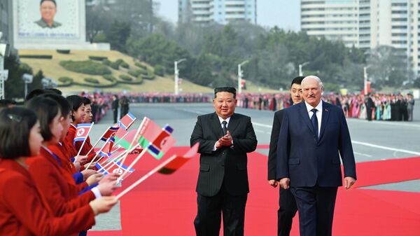 In this photo released by Belarus' Presidential Press Service, North Korea's leader Kim Jong Un, center, and Belarusian President Alexander Lukashenko, right, attend an official meeting ceremony in Pyongyang, North Korea, Wednesday, March 25, 2026.  - Sputnik International