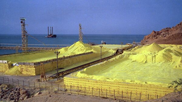 Yellow sulphur, a byproduct of petrochemical refinement, contrasts with the blue sea at Kharg Island, Iran, July 1971.  - Sputnik International